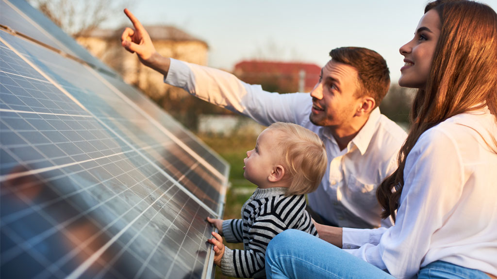 Family looking up at solar panels