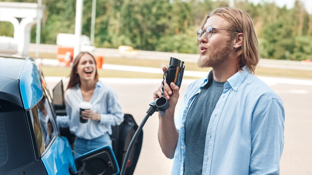 Couple using charging station