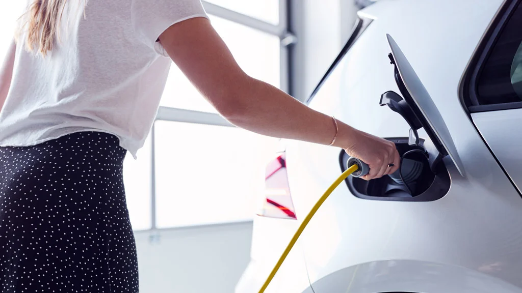 Woman Charging EV at Home