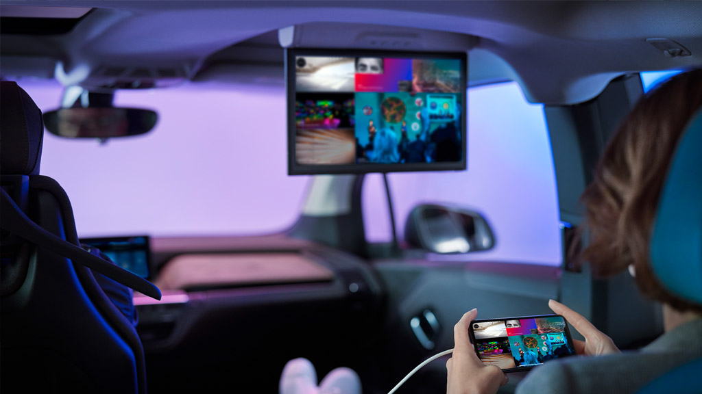 A BMW i3 with a womaen using the infotainment system