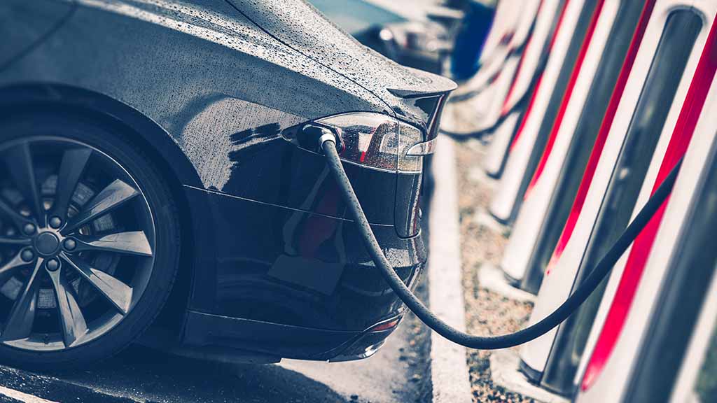 Close up of Tesla charging in a public charging station