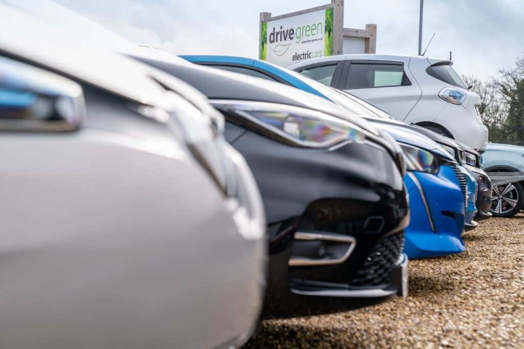 row of electric cars on the drive green forecourt