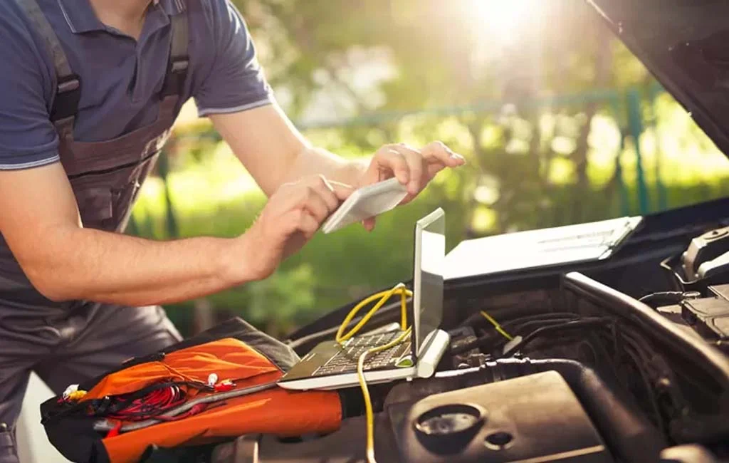 man entering servicing info into a device