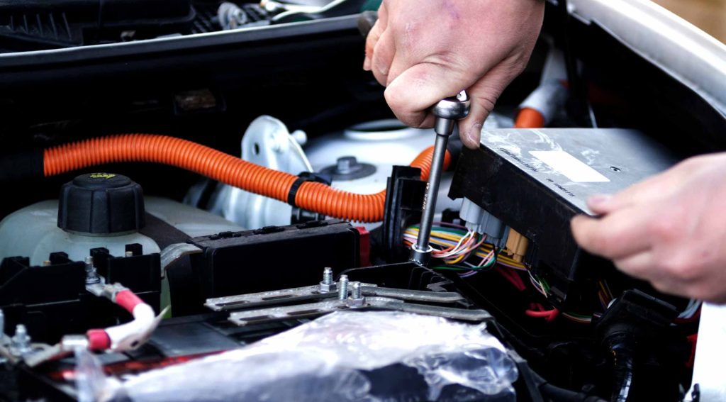 A man servicing an EV