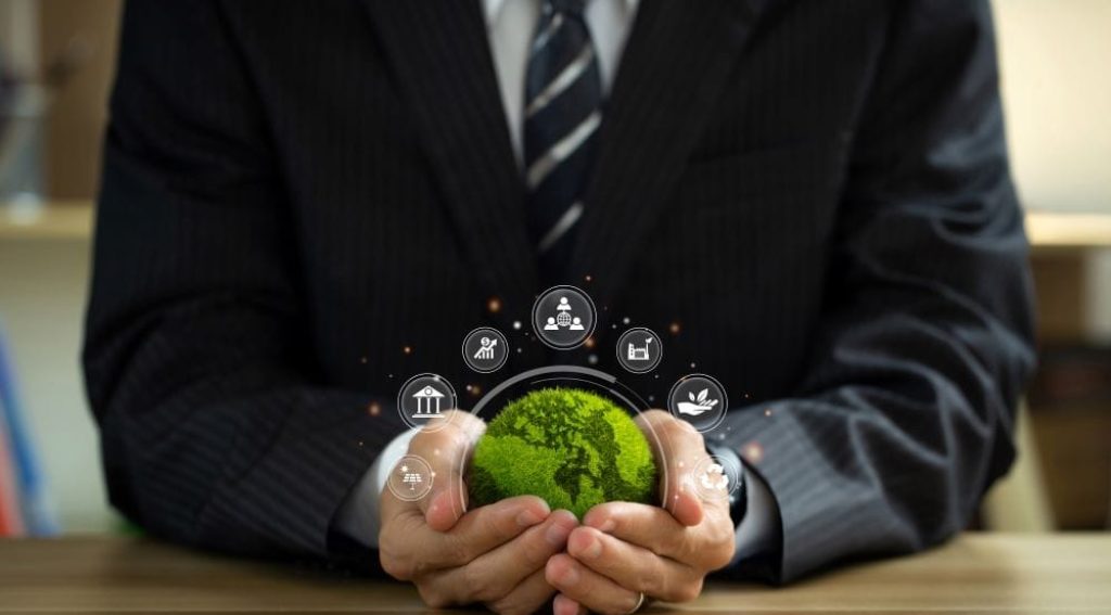 business man holding eartth and sustainability symbols