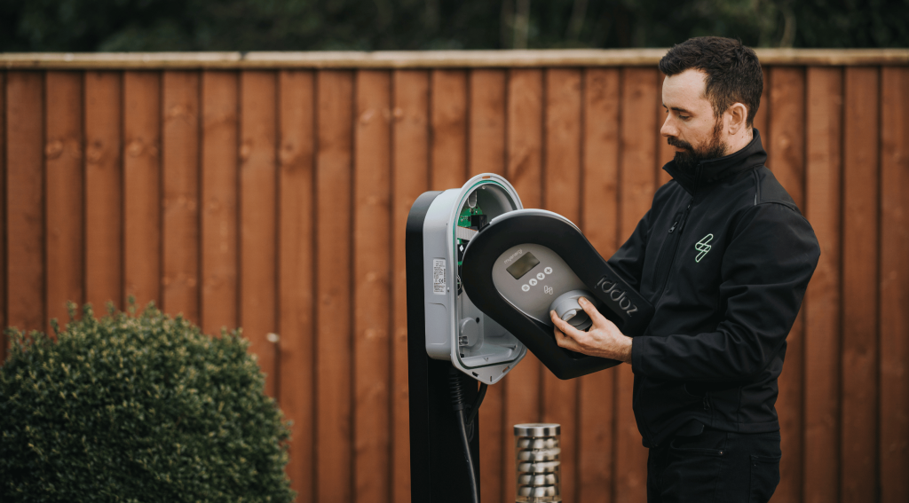 man pluggin in to a zappi charger